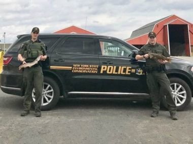 ECOs McFee and Noyes with illegally caught northern pike and bass